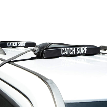 Catch Surf Surf Rack Single Black main view showing secure soft mounting for car transport.