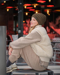 C.C beanie with winter scenery on model, versatile cold-weather look