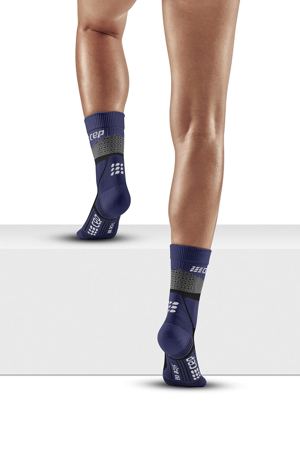 CEP Max Cushion socks on a climber portrait emphasize moisture-wicking and comfort during variable terrain.