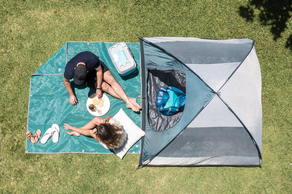 CGEAR Original Sand-Free Outdoor Rug at a family picnic for tidy seating