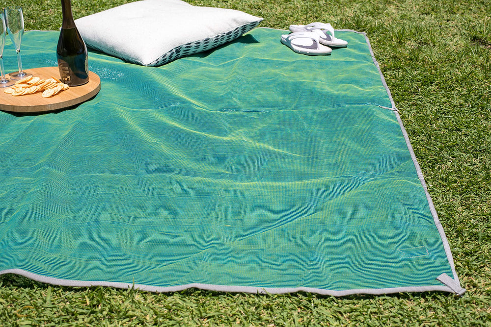 CGEAR Original Sand-Free Outdoor Rug flip highlights reversible colors for versatile style