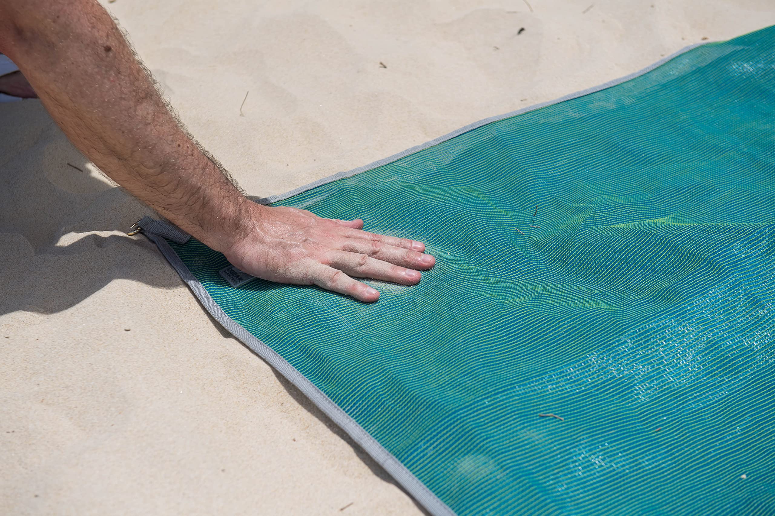 CGEAR Original Sand-Free Outdoor Rug rolled into its drawstring bag for easy packing