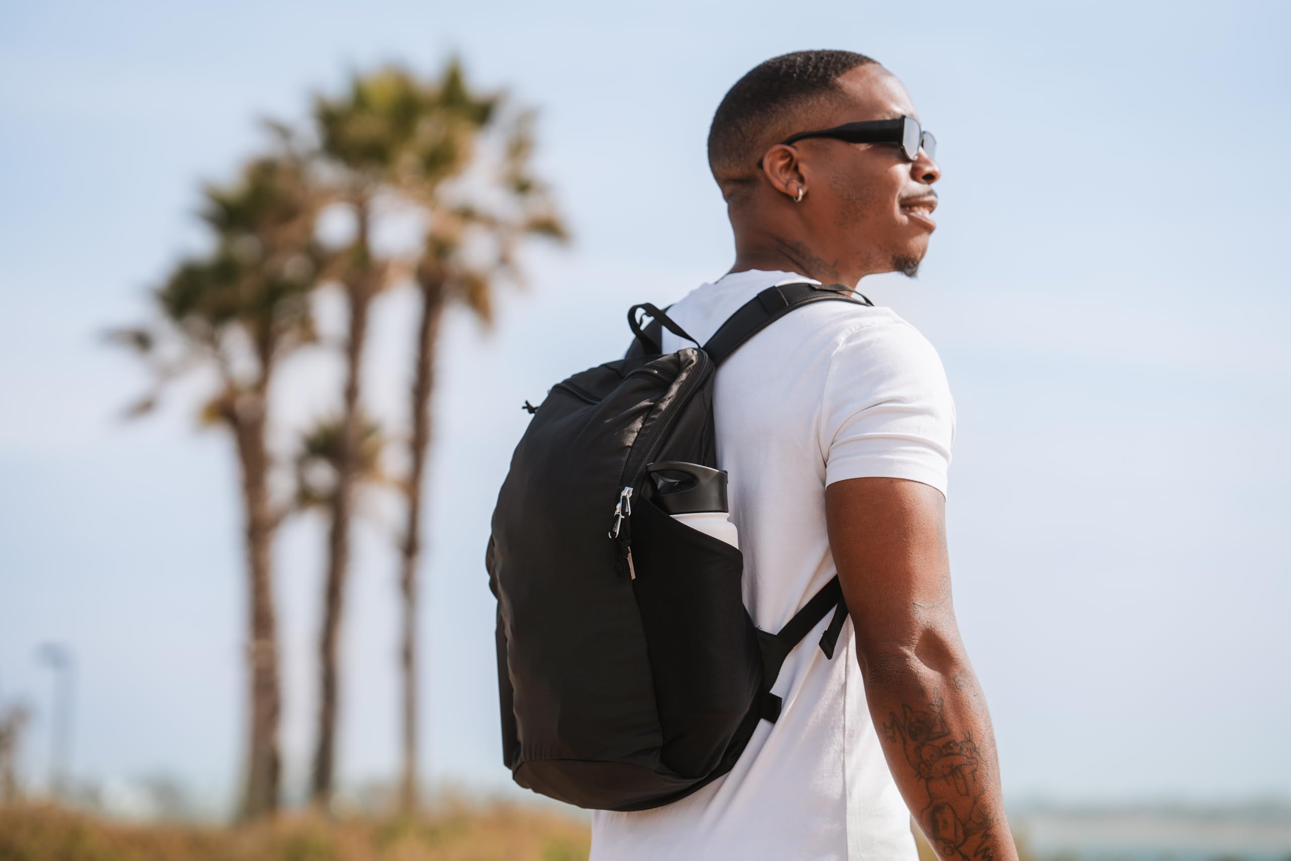 ChicoBag Travel Pack rePETe + Refine Sapphire metal carabiner clip attaches gear anywhere.