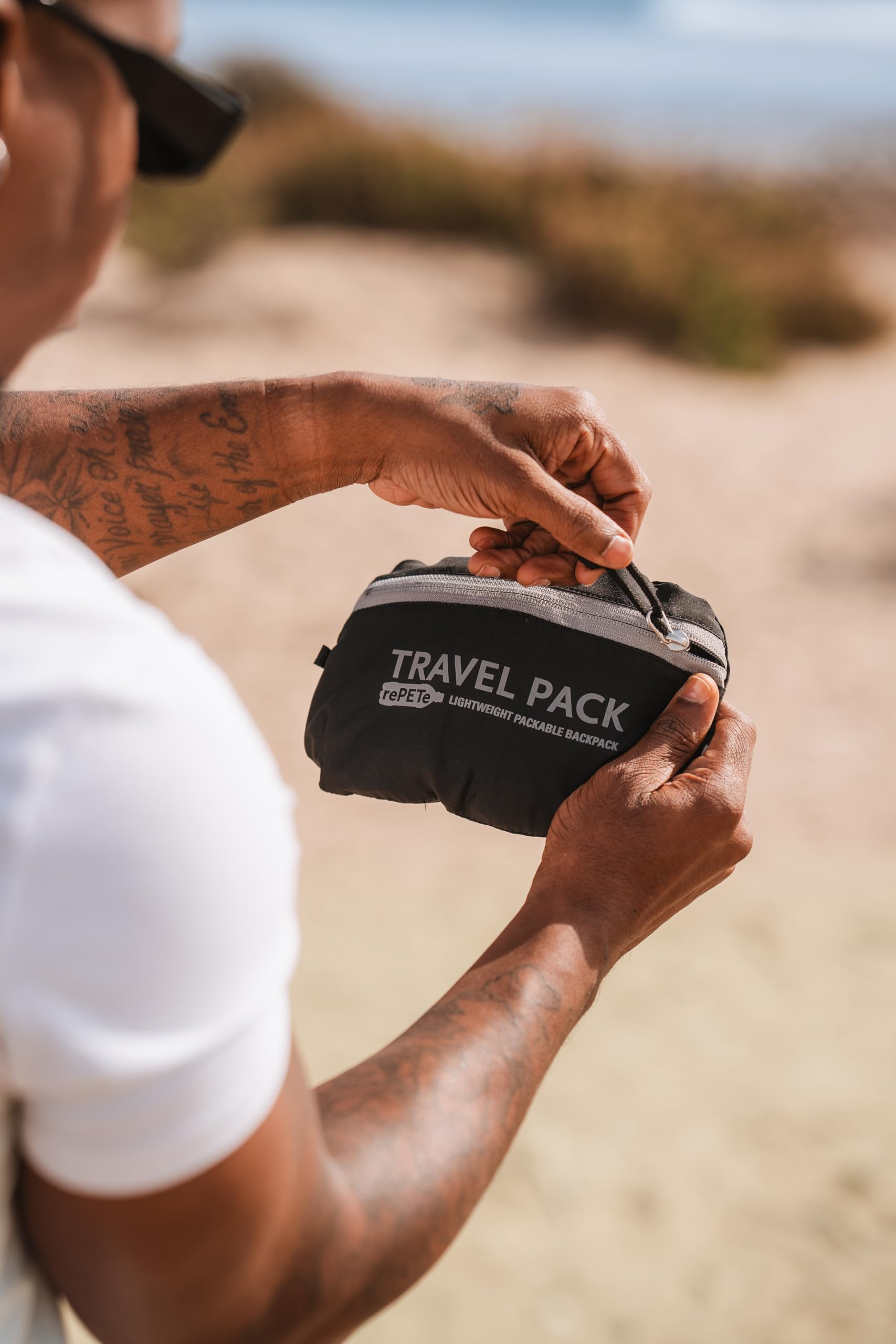 ChicoBag Travel Pack rePETe + Refine Sapphire hydration reservoir area for on-the-go hydration.