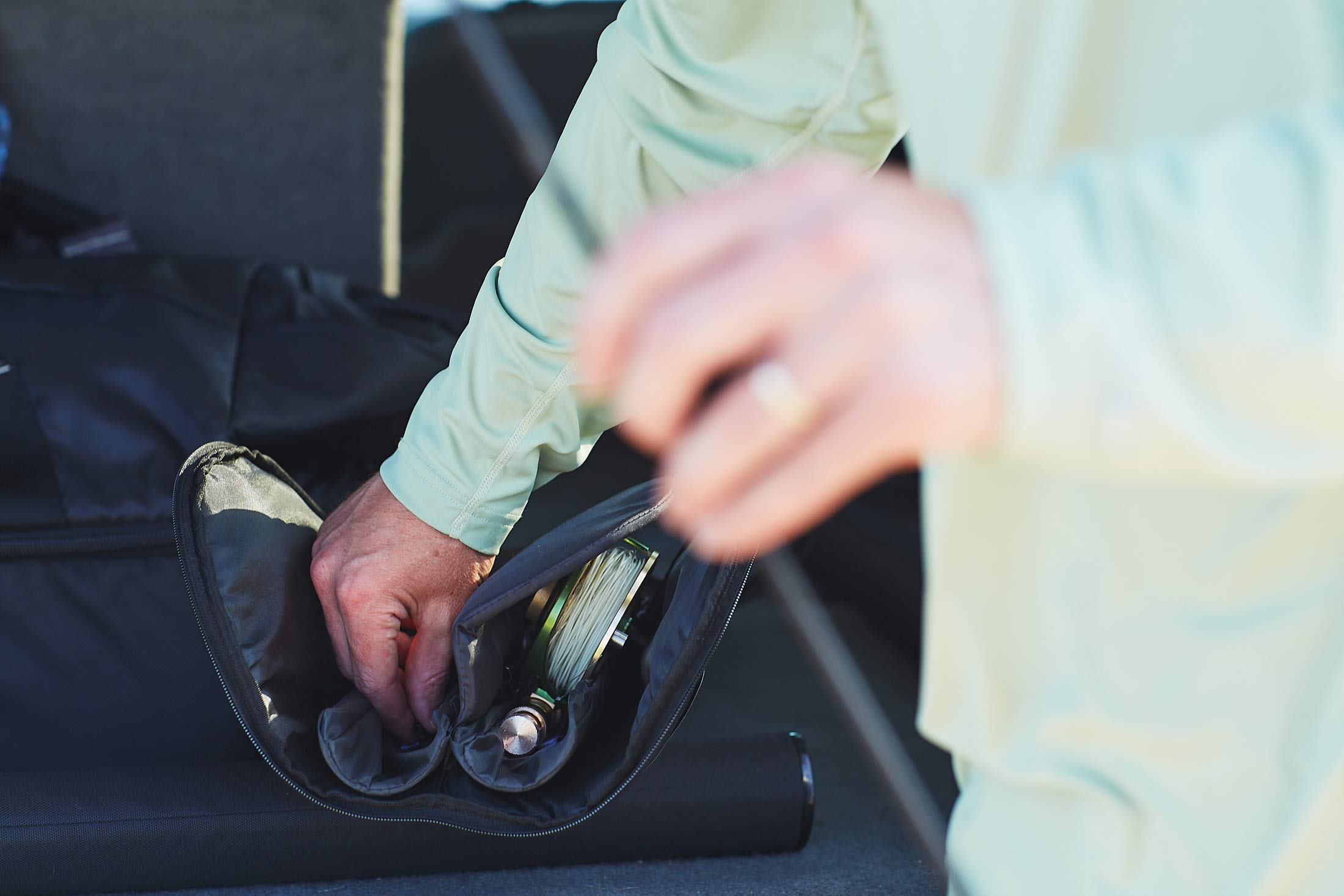 Padded dual reel compartment with divider