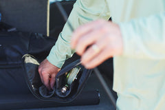 Padded dual reel compartment with divider