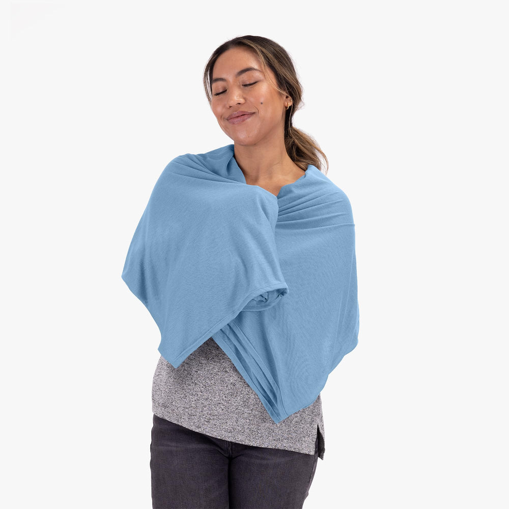 COCOON Premium travel blanket draped on sofa for versatile comfort at home.