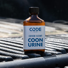 Code Blue Coon Urine 2-ounce bottle ready for field use.