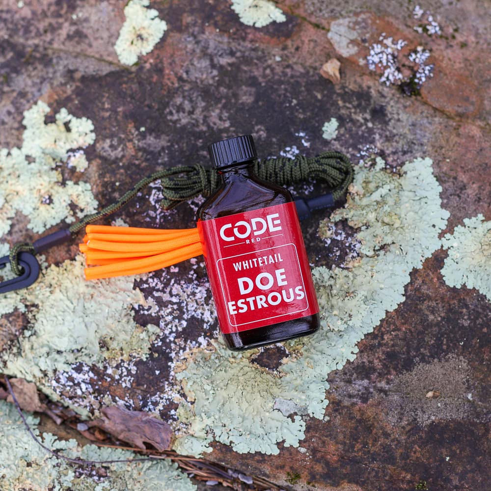 Code Blue Doe Estrous Drag amber bottle close-up, preserves freshness for field use