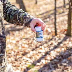 Wax-stick scent being applied to a branch