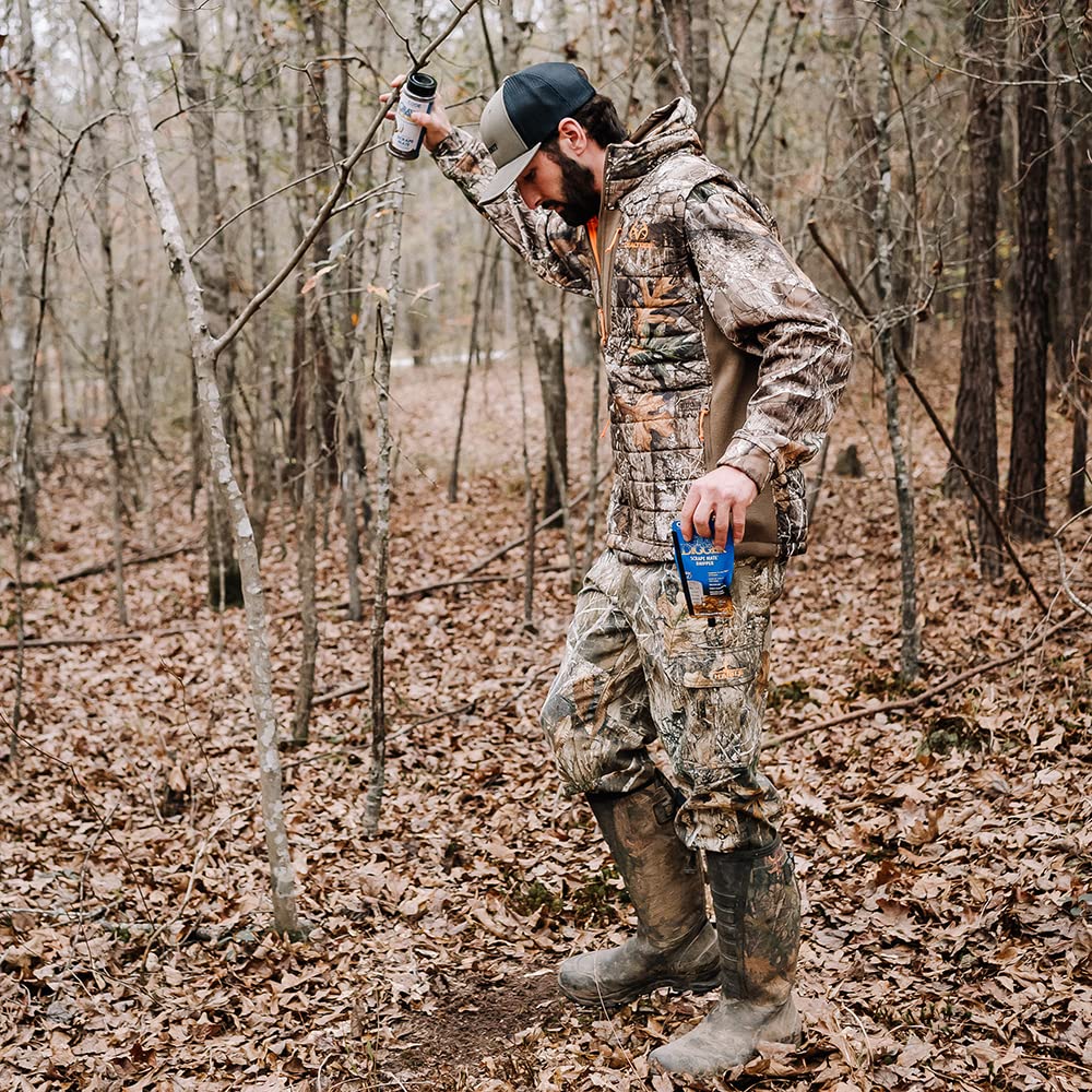 Code Blue Grave Digger Dripper hanging on a branch to deploy scent naturally.