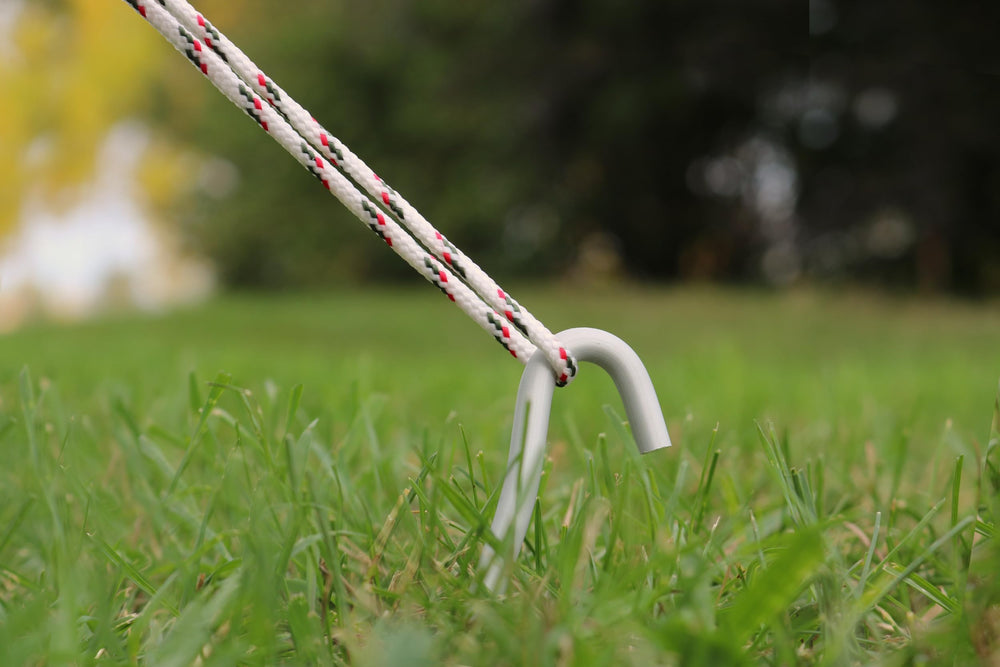 Coghlan's four-pack aluminum stakes ideal for tents, tarps, and netting.
