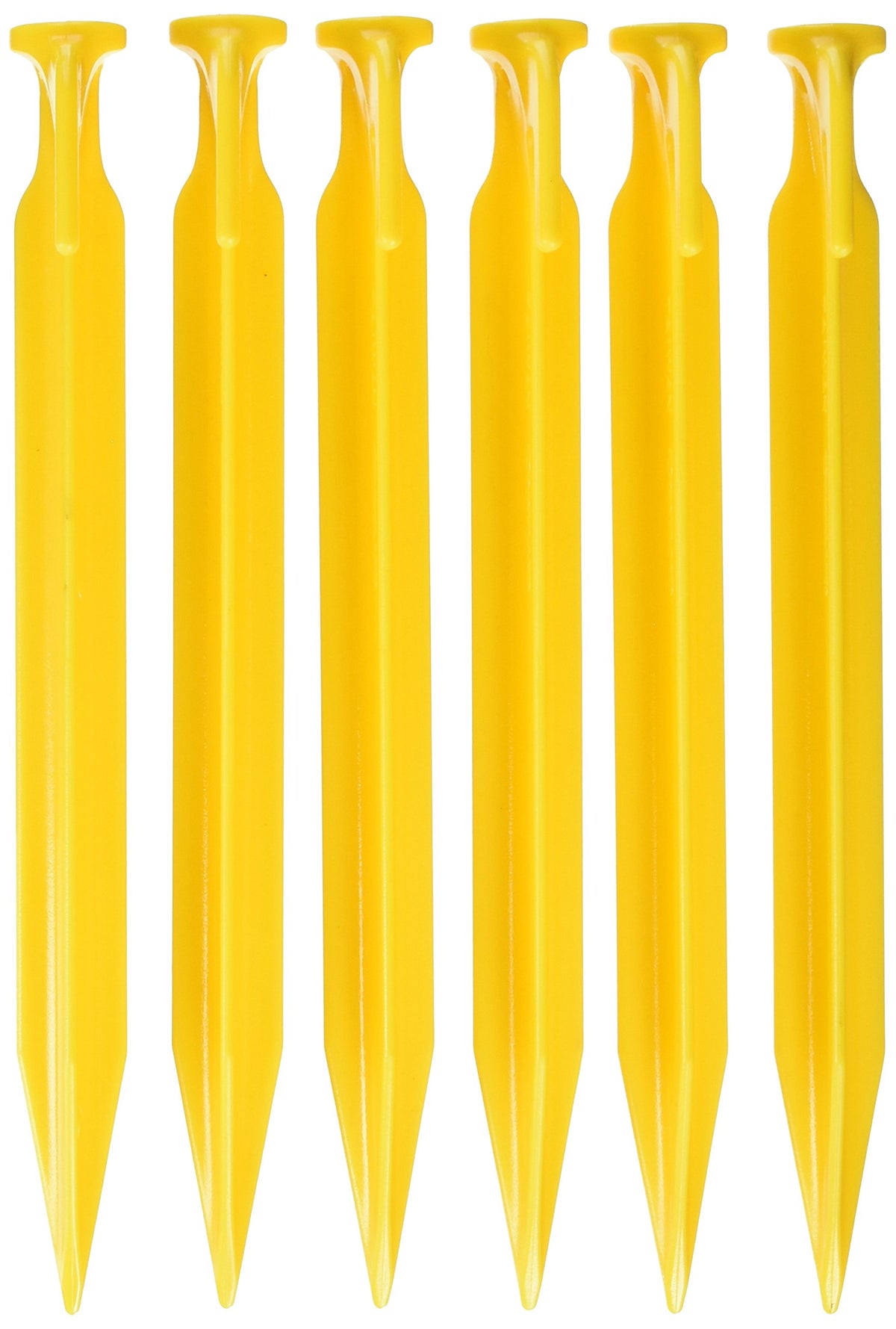 Coghlan's 9-inch ABS tent pegs anchored in soil for secure camping setup