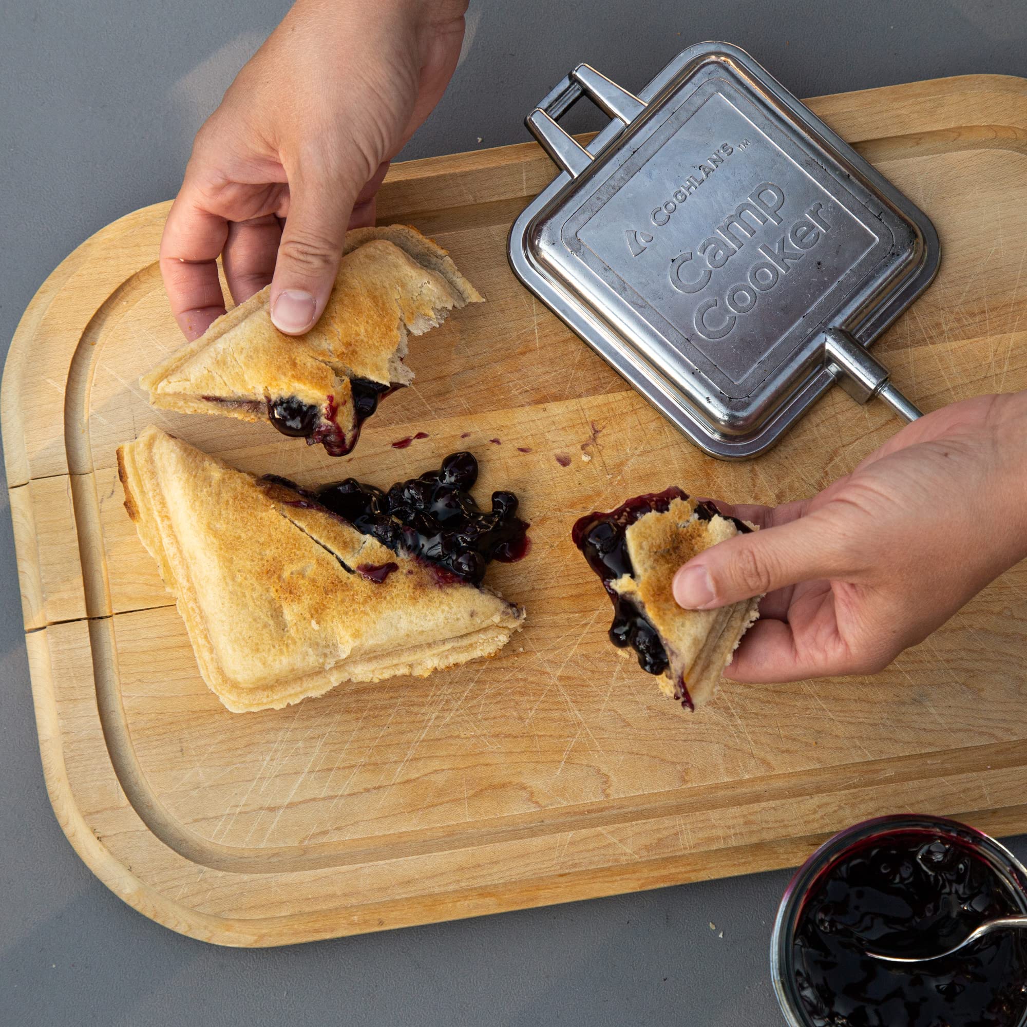 Toasting sandwiches with Coghlans camp cooker over a campfire