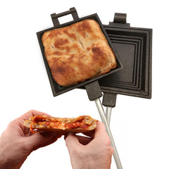 Coghlan's camp cooker in action toasts pies by campfire