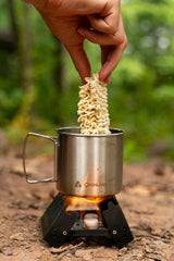 Coghlan's Emergency Stove outdoors ready for fast water boiling