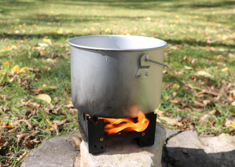 Coghlan's emergency stove with tablets demonstrating smokeless ignition for outdoor heat
