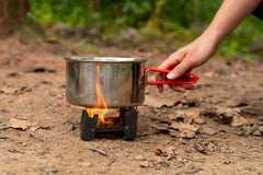 Coghlan's Emergency Stove shown with Fire Discs for versatile heat