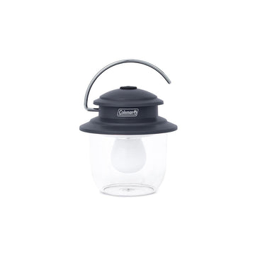 Coleman Classic LED Lantern on a table providing bright campsite lighting up to 300 lumens.