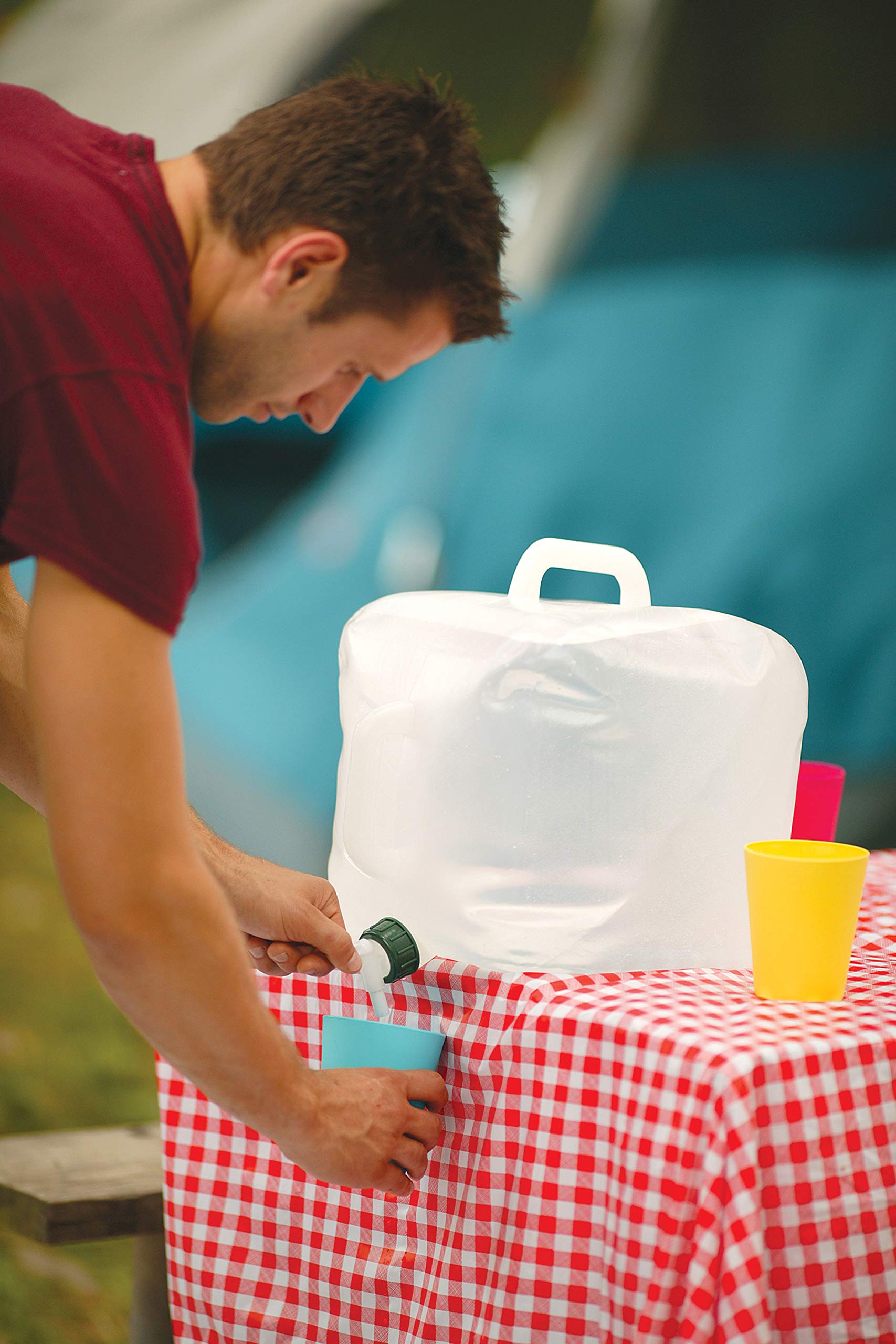 Collapsible Coleman water carrier folded flat for compact camping storage.