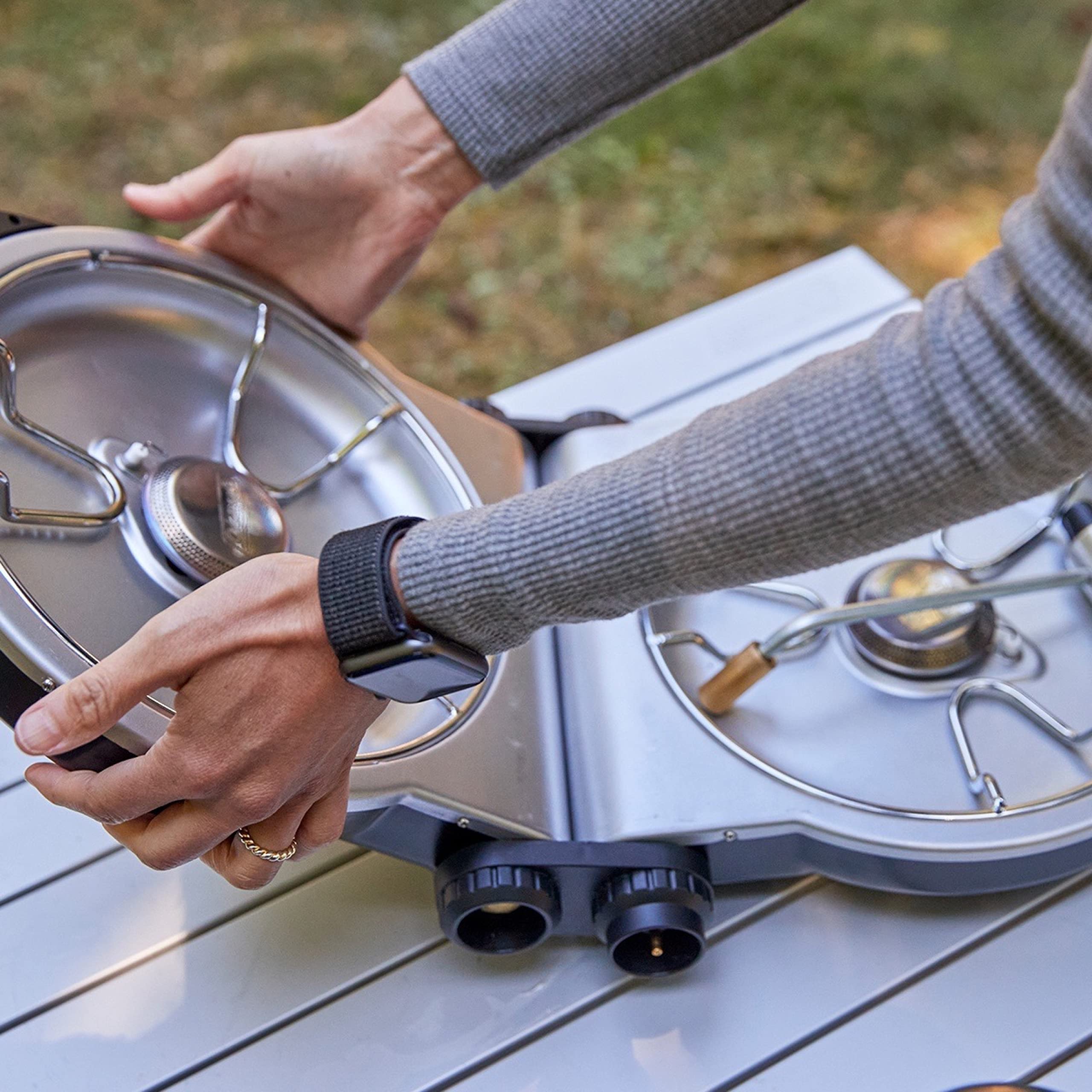Coleman Fold N Go stove fits two 10-inch pans for flexible meal setups.