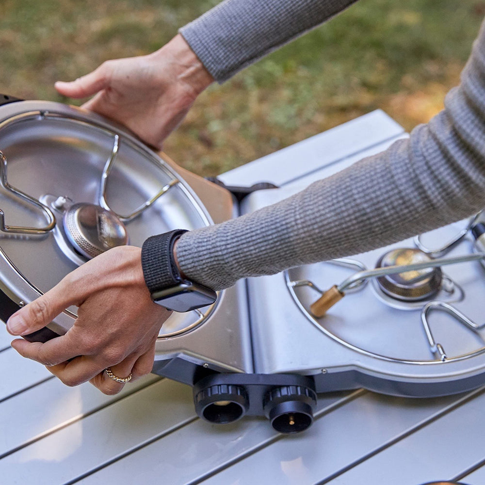 Coleman Fold N Go stove fits two 10-inch pans for flexible meal setups.
