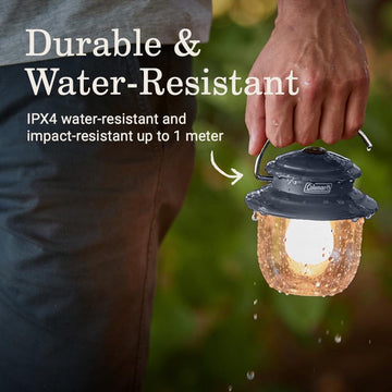 Coleman lantern subjected to splashes with IPX4 water resistance for outdoor reliability.