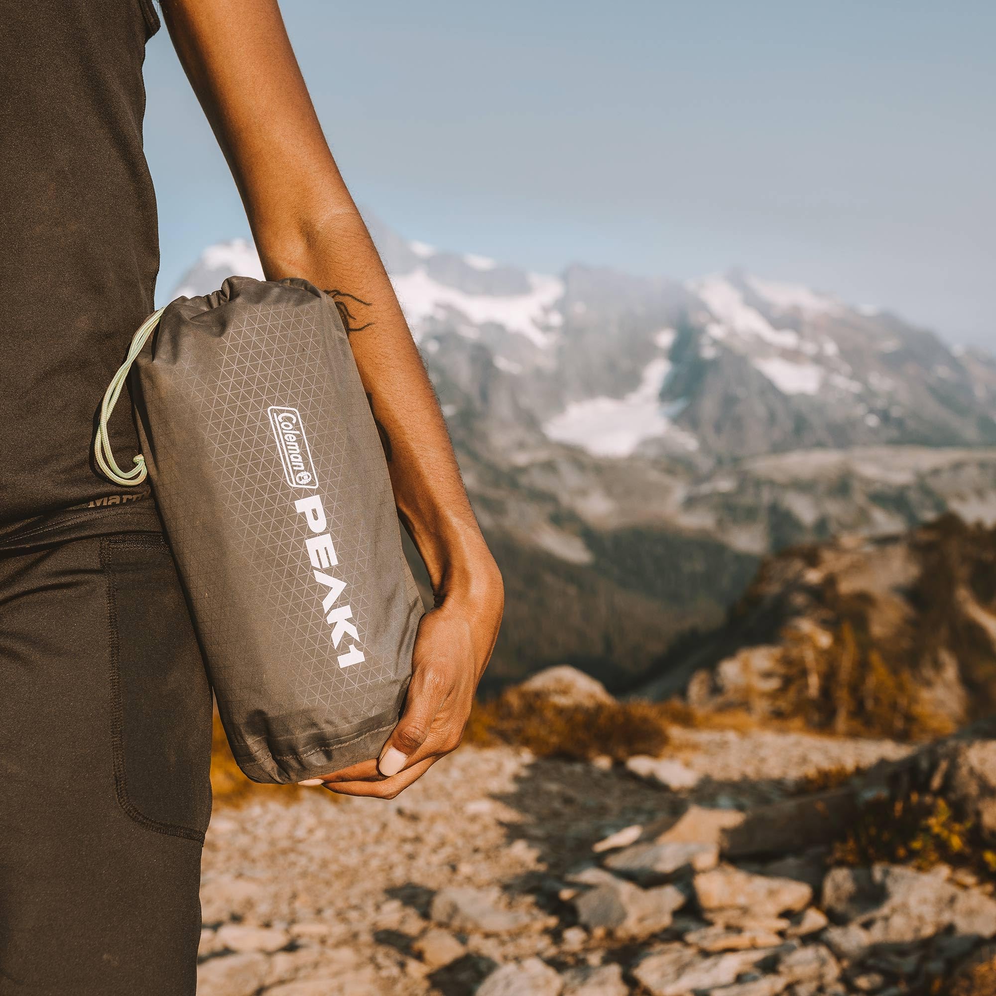 Coleman PEAK1 pad provides elevated comfort on uneven ground.