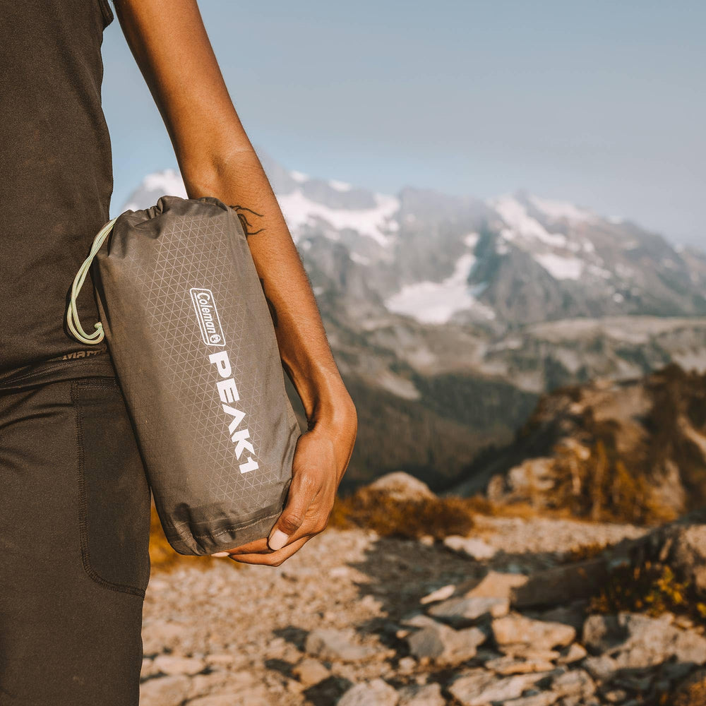 Coleman PEAK1 pad provides elevated comfort on uneven ground.