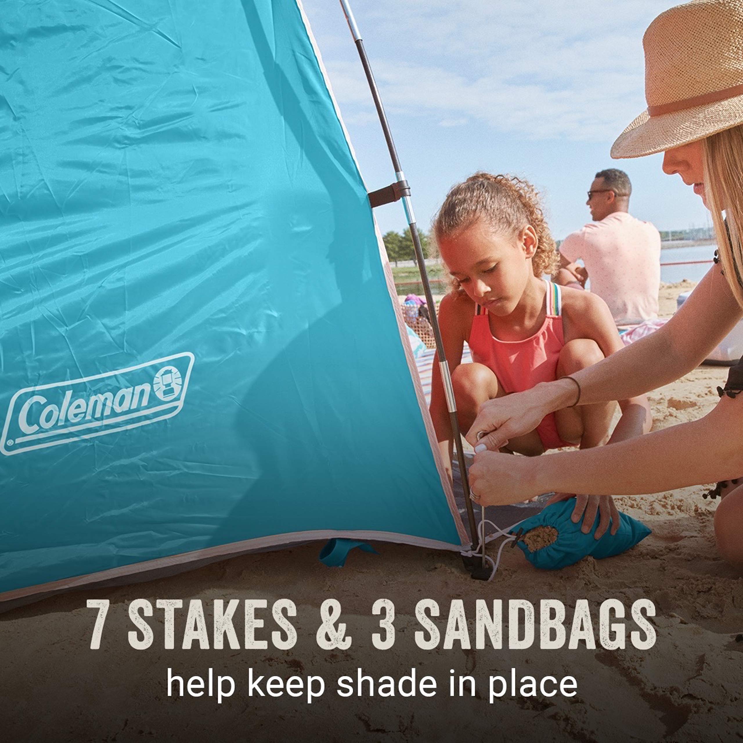 Seven stakes and three sandbags stabilize Coleman Skyshade on windy beaches.