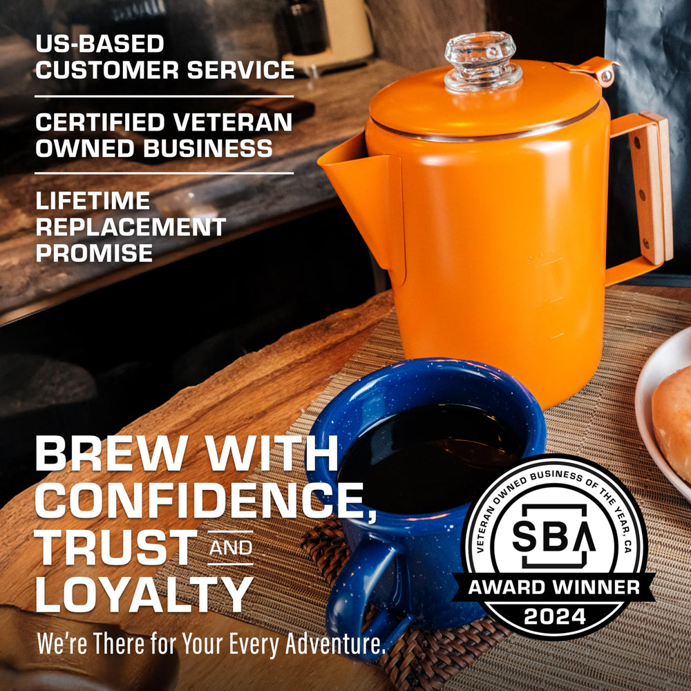 COLETTI Bozeman orange percolator in-use by campfire for rich aroma.