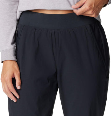 Columbia Leslie Falls Pant action shot on rocky path emphasizes built-for-movement design.
