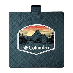 Columbia packable tote blanket spread on grass for a cozy picnic.