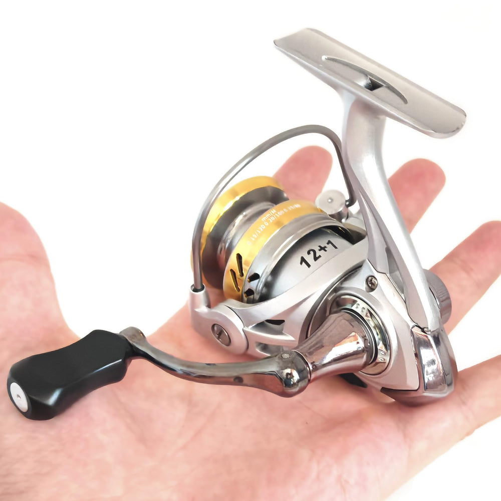 Compact spinning reel on ice in gold finish with foldable handle