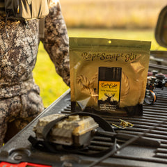 Conquest Scents mock scrape licking branch setup demonstrates high-traffic deer activity.