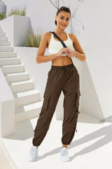 COPYLEAF women's parachute cargo pants offer elastic waistband and cuffs for versatile fit.