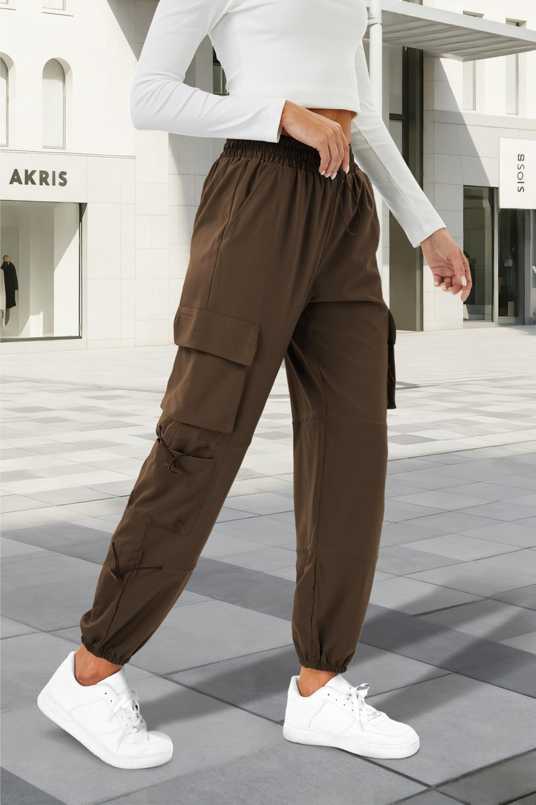 COPYLEAF women's parachute cargo pants reveal six secure pockets for gear during hikes.