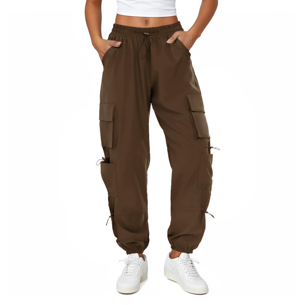 COPYLEAF women's parachute cargo pants show water-resistant coating for wet conditions.