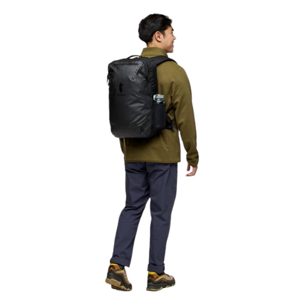 Cotopaxi Allpa 28L travel pack black luggage pass-through demonstrates easy stacking with rolling bags