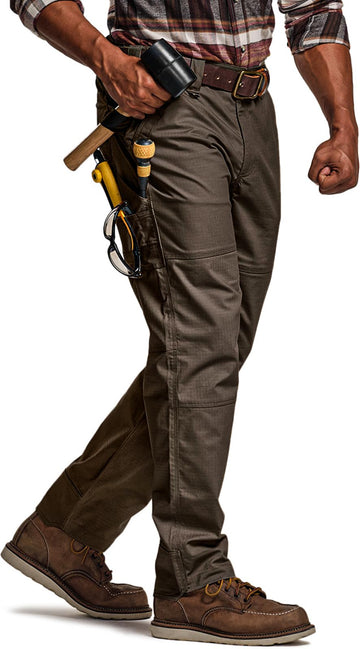 CQR men's quick dry work pants with water resistance in rugged outdoor setting