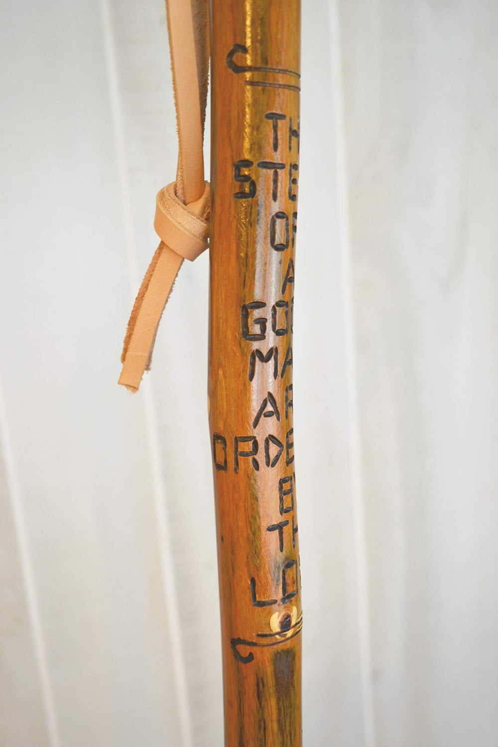 CreationCarvings hardwood walking stick with rubber tip for stable footing on trails.