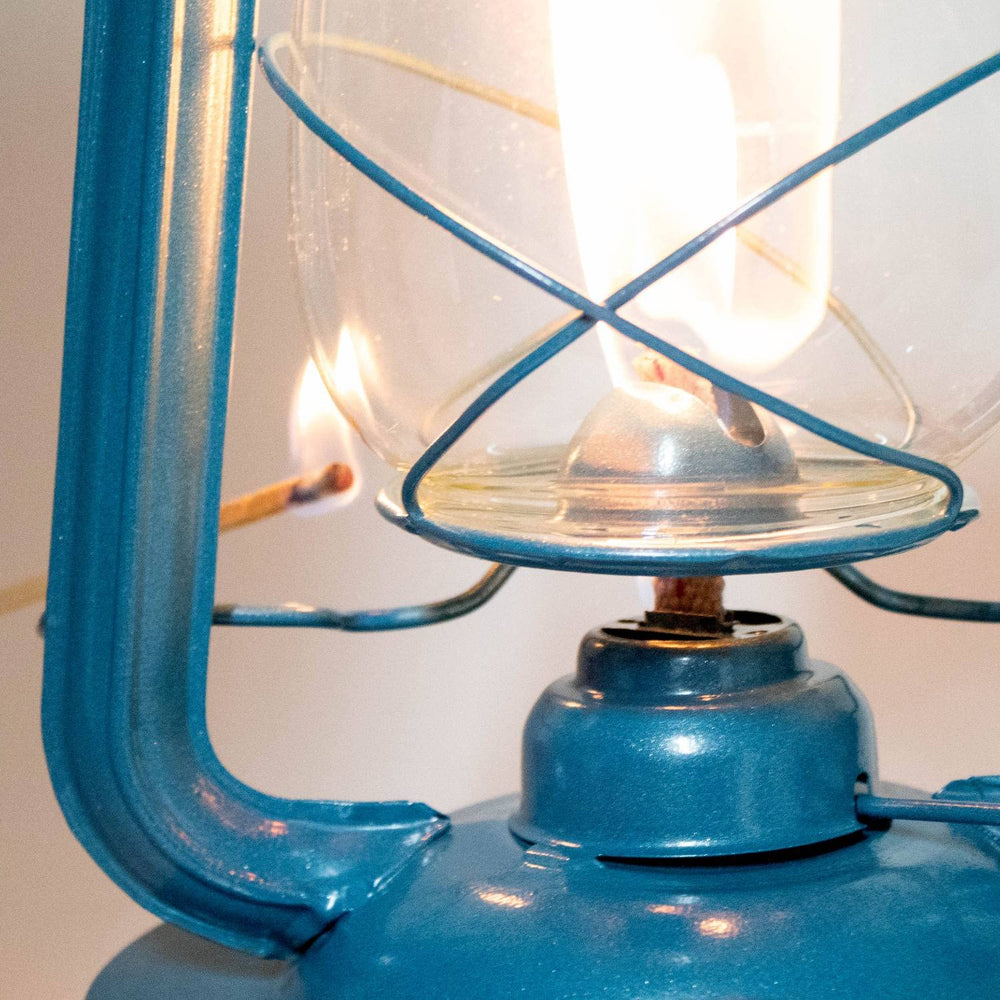 Glass globe with wire cage reduces breakage during travel and camping