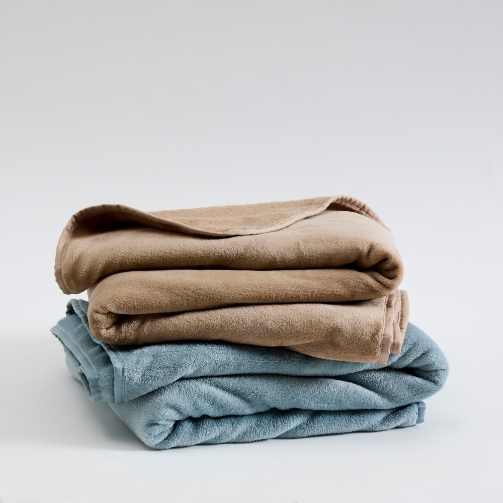 Cuddledown Gulf Blue blanket with cotton sateen edge adds refined style.