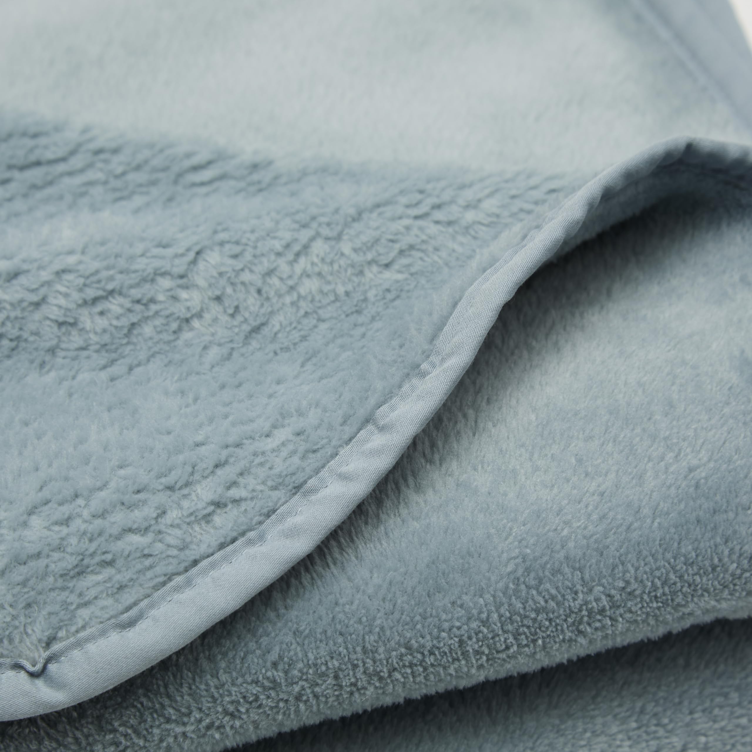 Cuddledown plush fleece travel blanket unfolded to reveal velvety-soft texture.