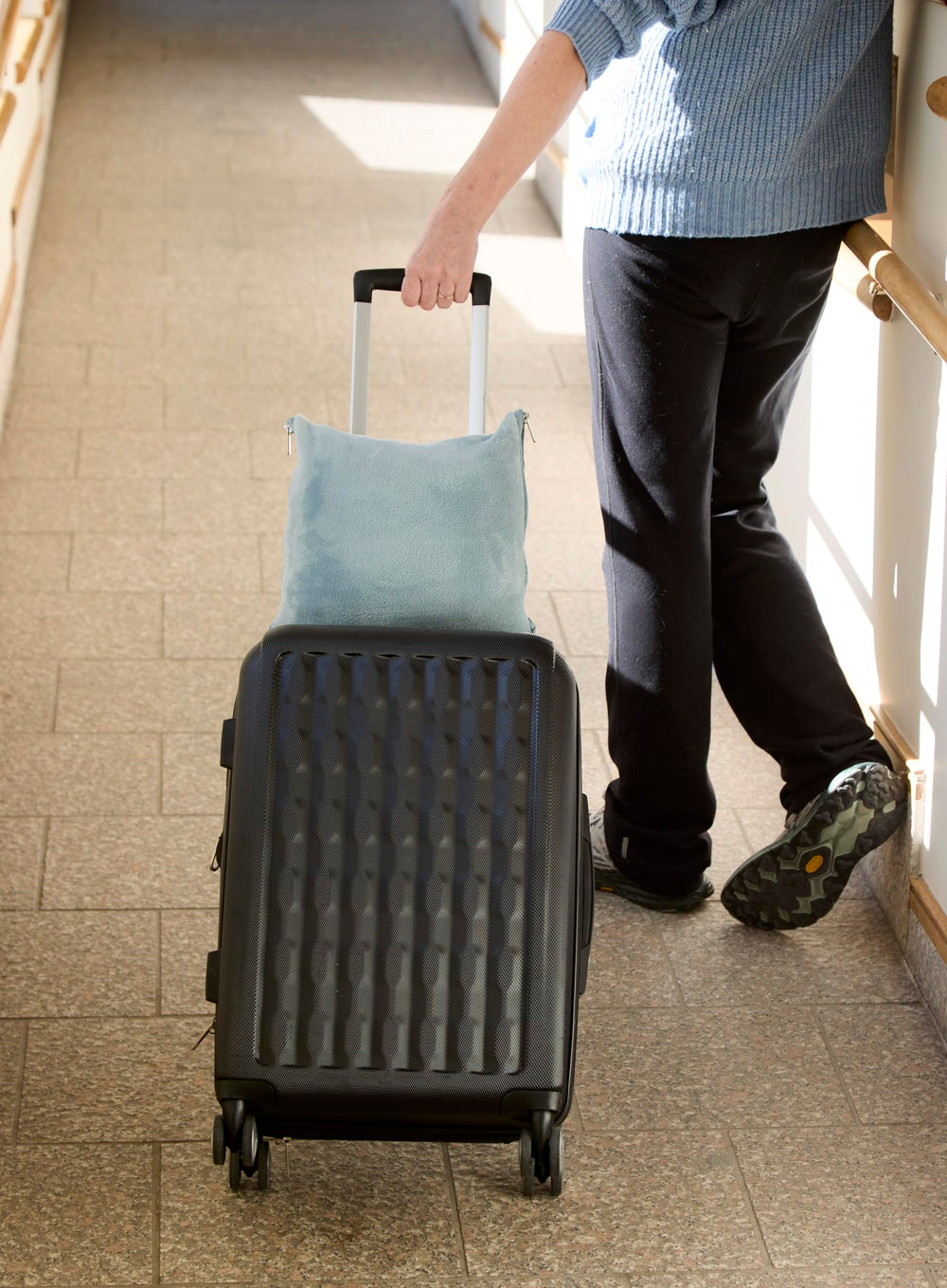 Cuddledown travel blanket used as a pillow for convenient on-the-go comfort.