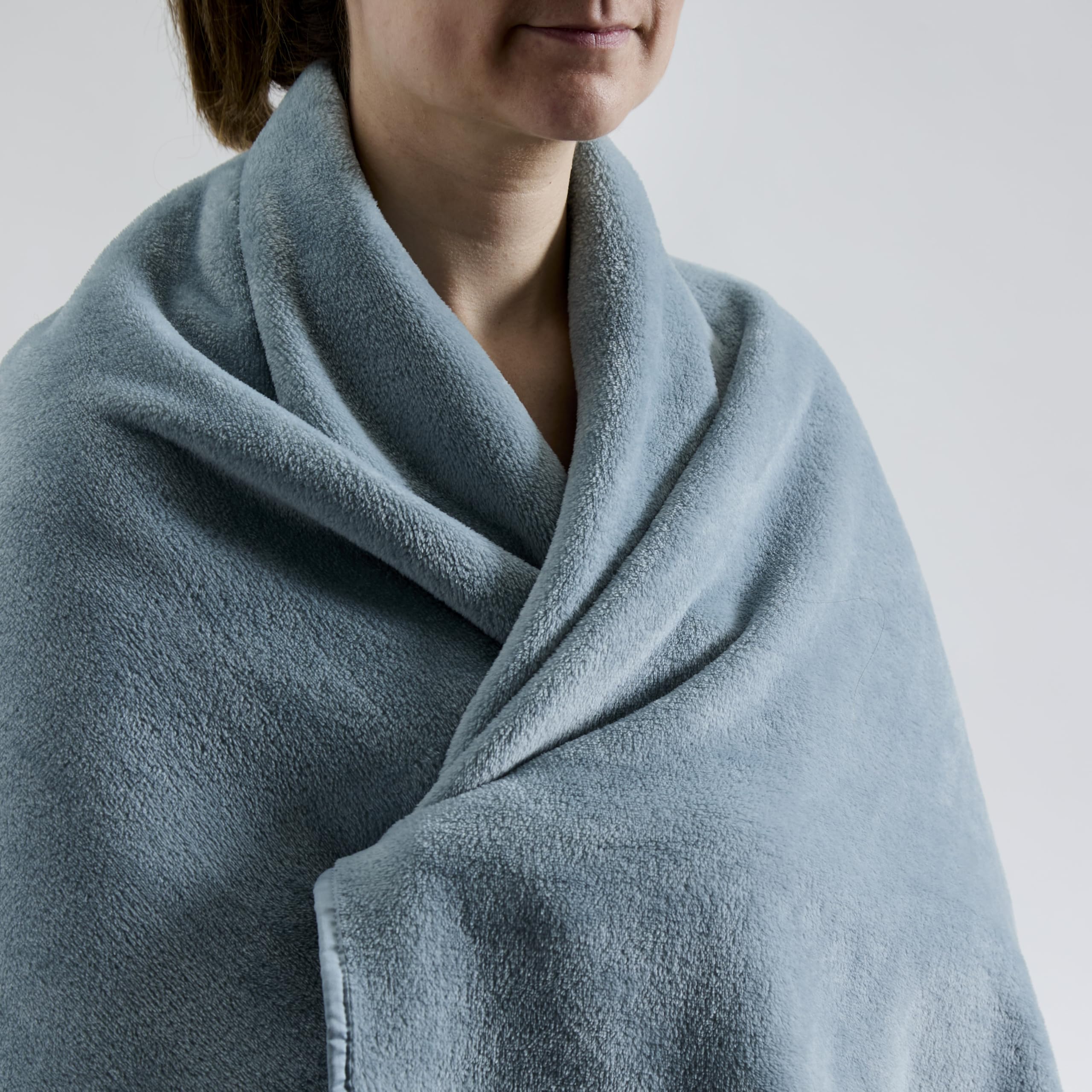 Cuddledown travel blanket stored in its bag with adjustable strap for easy carry.