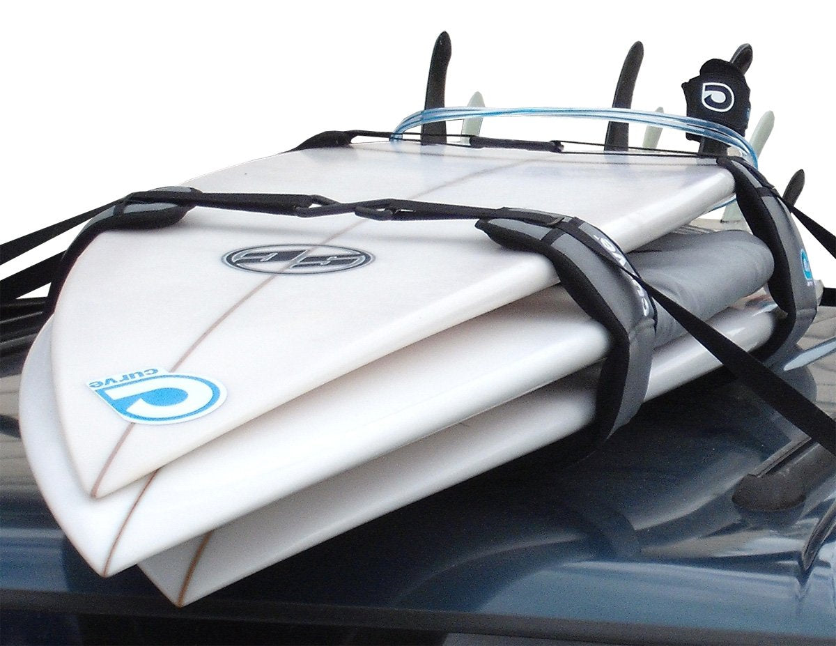 Curve Lockdown system on car roof cocooning surfboards for secure transport.