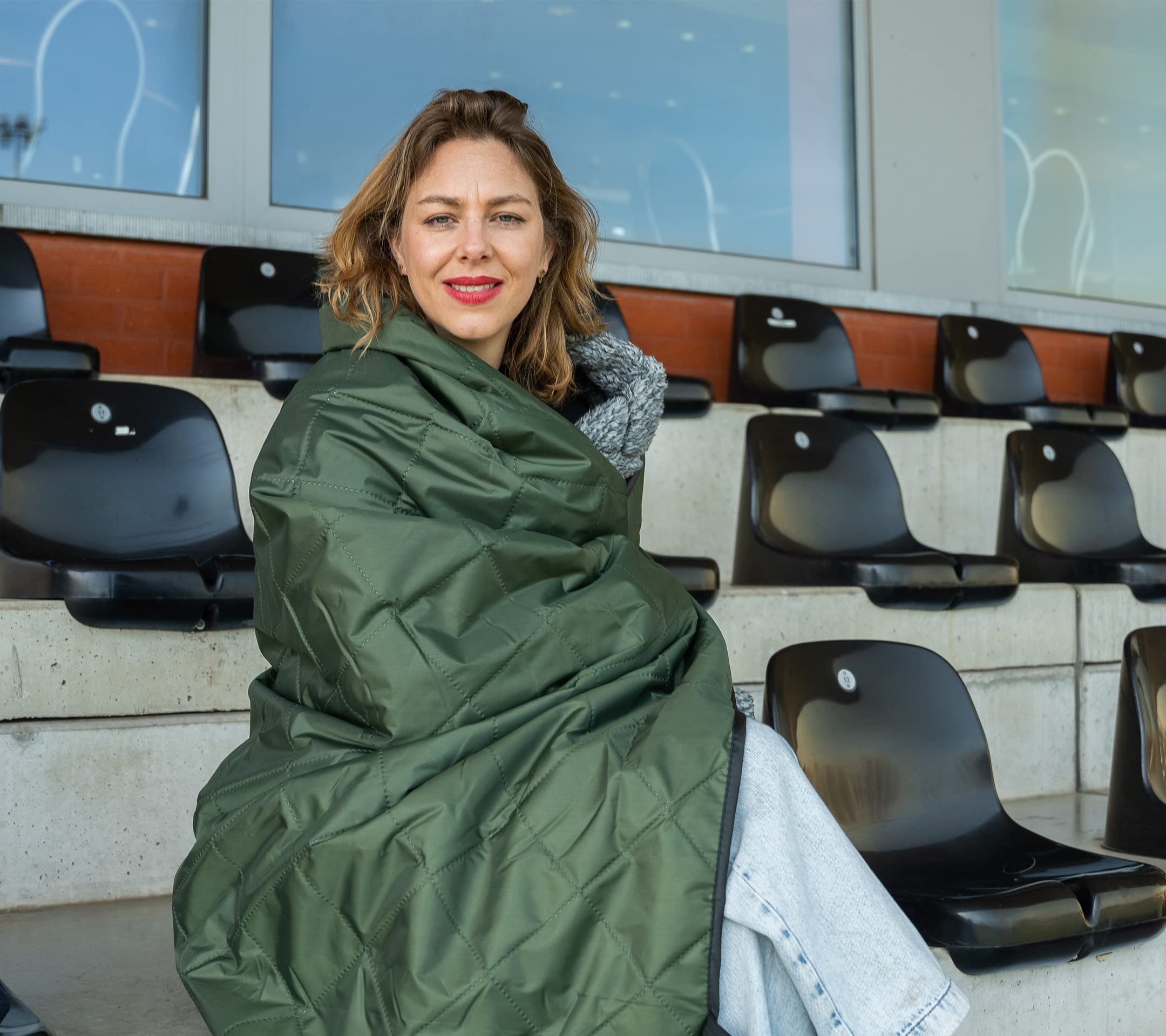 Dagmi Outdoors Sherpa Blanket in stadium setting illustrates roomy 78 by 55 inches