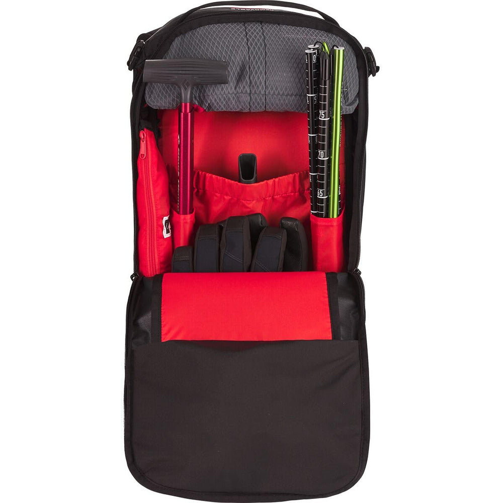 Dakine Poacher RAS carrying skis or snowboard with diagonal or A-frame setup.