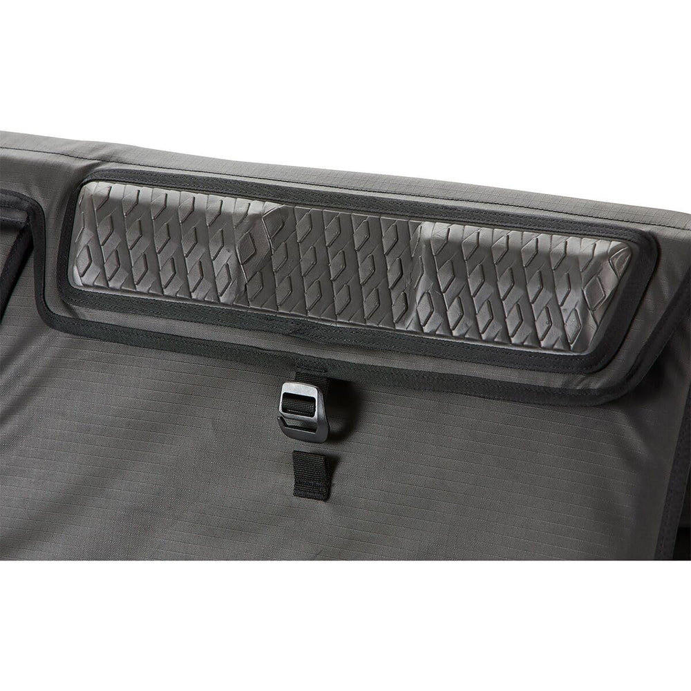 Dakine pad shows adjustable webbing anchor straps for secure fit
